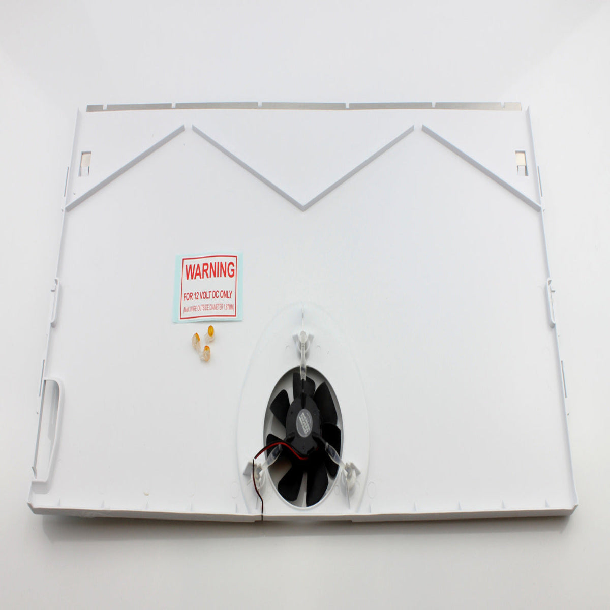 Metallic cooling fin with a warning label on a white background
