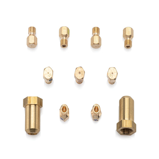 A set of brass 3D printer nozzle tips and adapter fittings arranged on a clean white background.