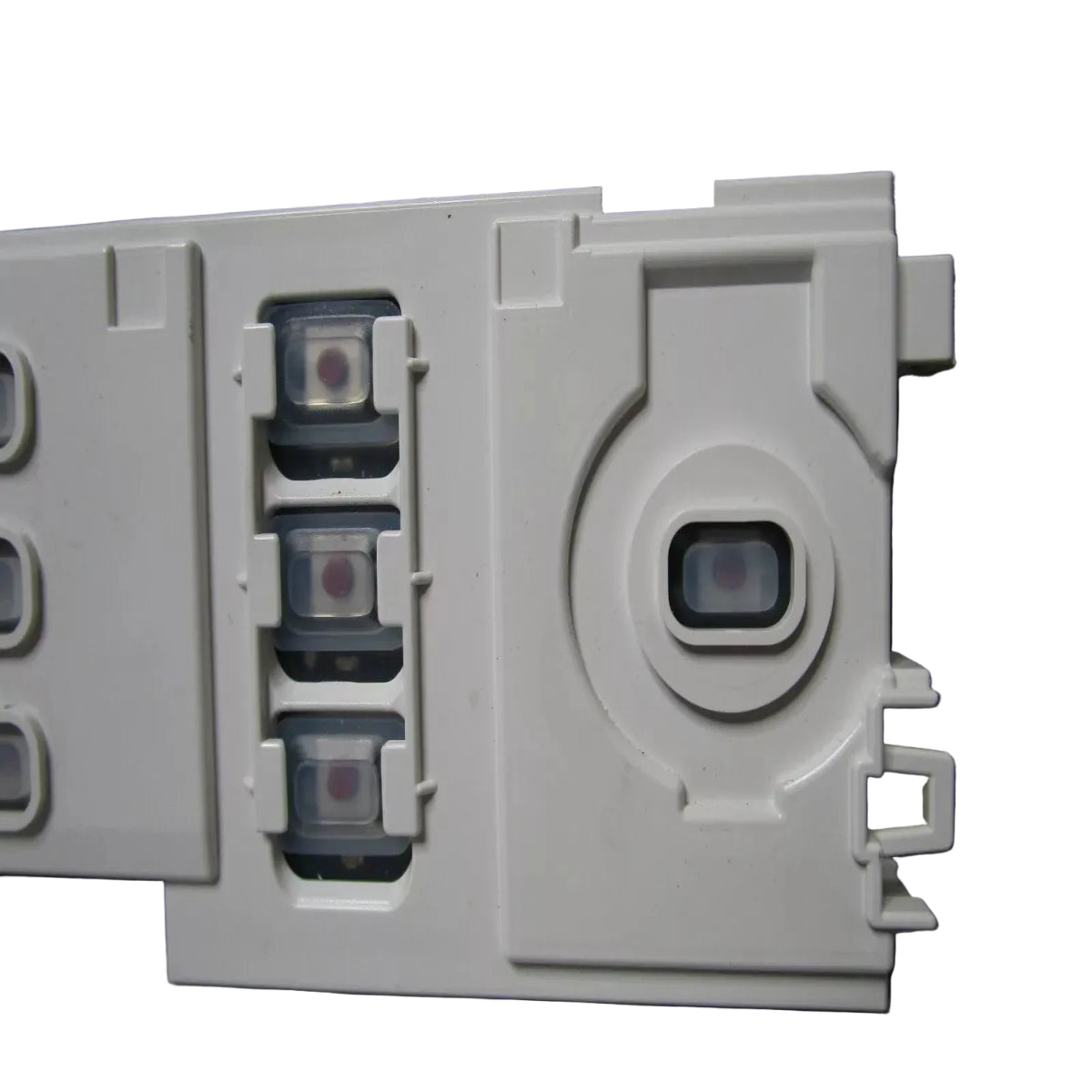 Close-up of a white electronic device with circular components on a dark background