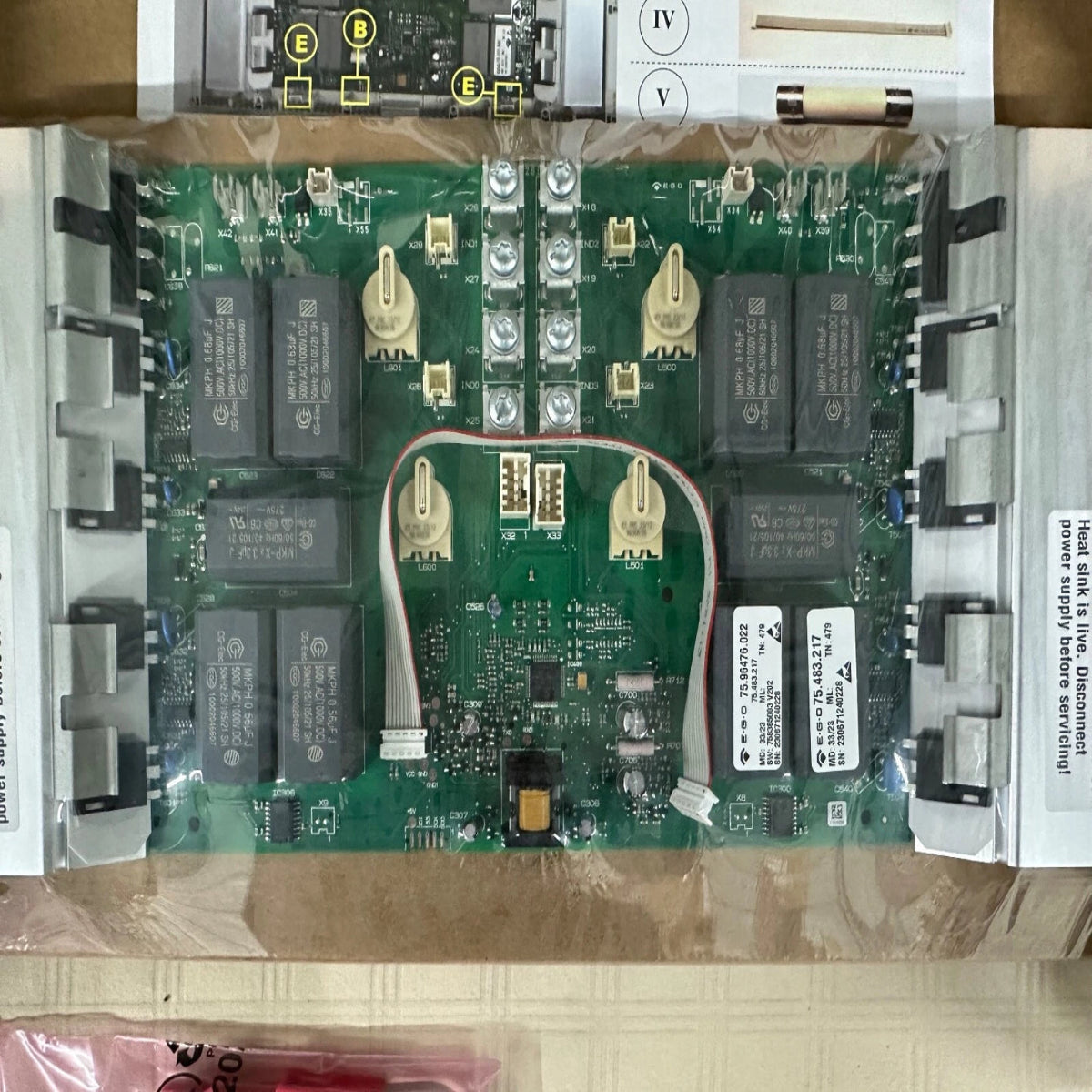 Electronic circuit board with various components on a cardboard surface